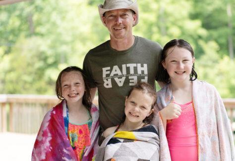 single dad and 3 daughters at Deer Run Summer Family Camp