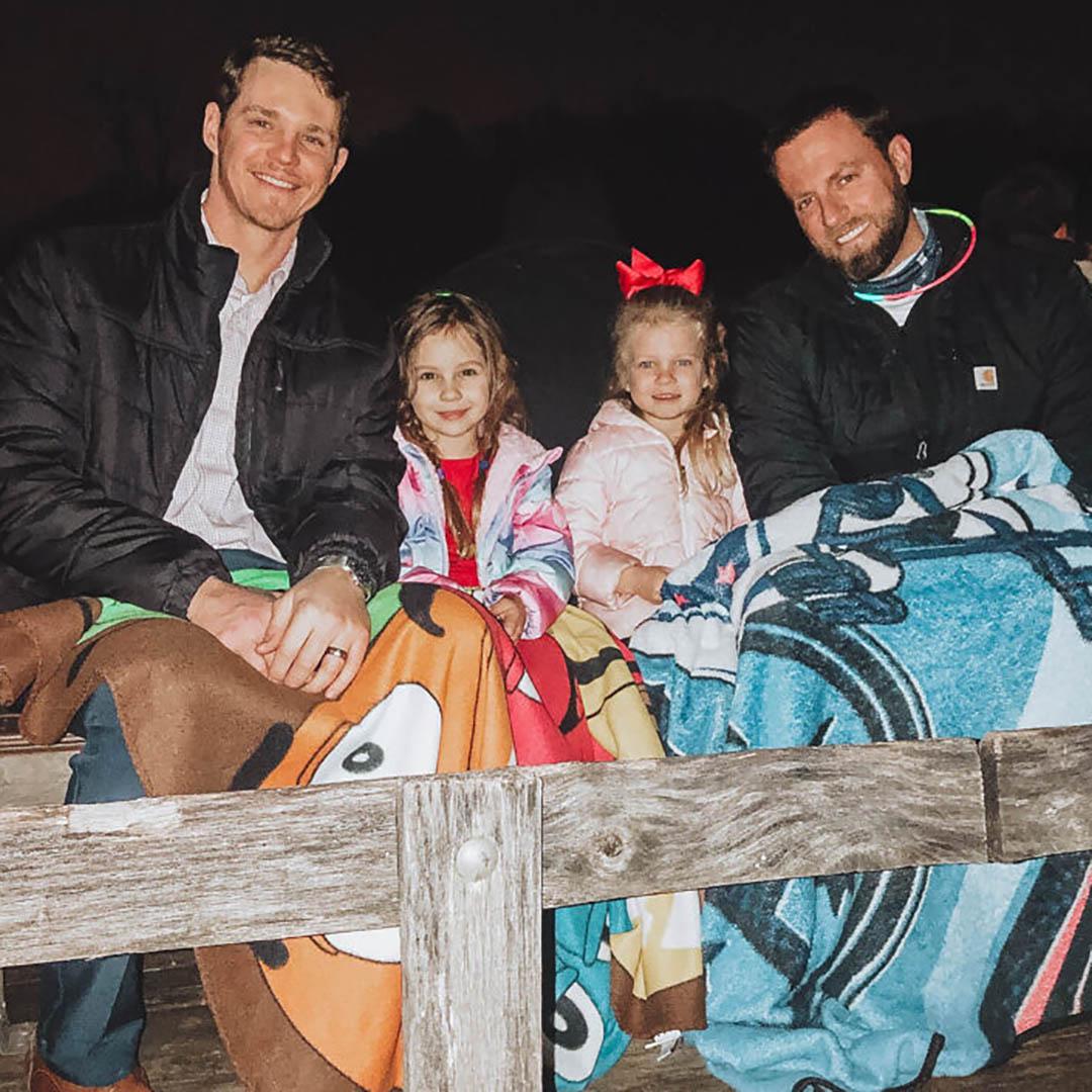 two dads and their girls wagon ride at Daddy Daughter Date Night at Deer Run Camps & Retreats