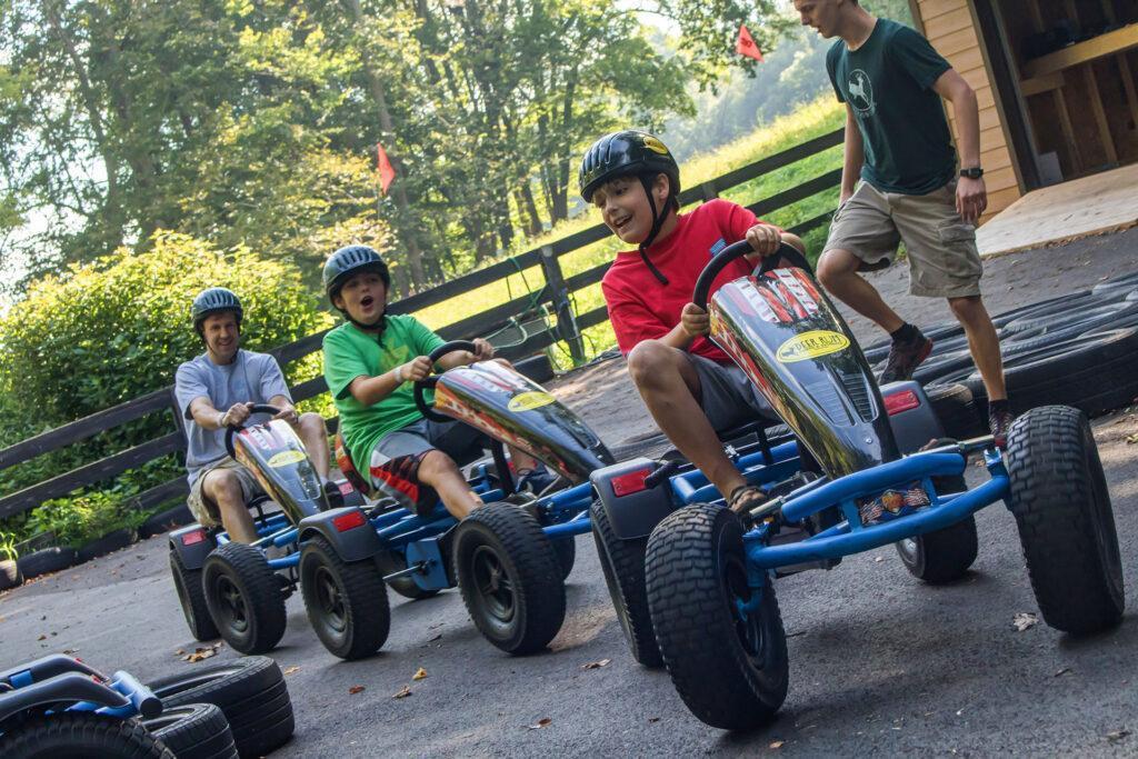 father and 2 sons riding pedal karts at Deer Run father son adventure weekend