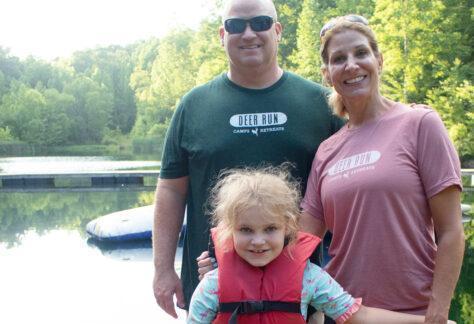 parents with daughter at spring valley lake attending Family Camp at Deer Run Camps & Retreats