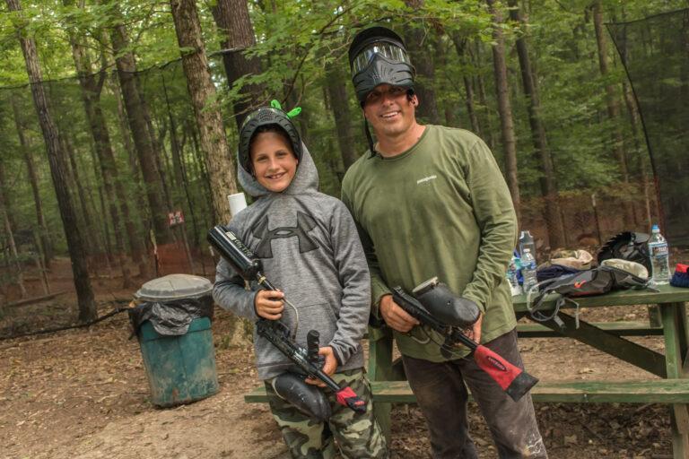 father and son ready for paintball at Deer Run Camps & Retreats