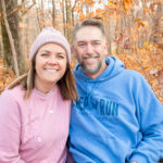 Married host couple smiling at Deer Run's November Married Couples Weekend