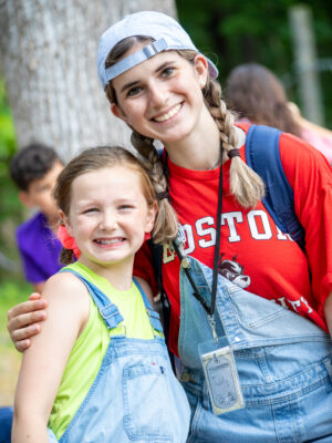 Summer Camp volunteer smiling with her girl camper.