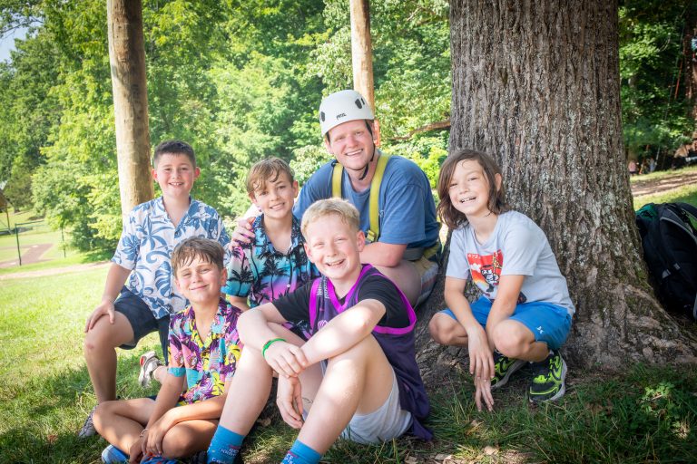 Camp Counselor and Campers at summer camp smiling