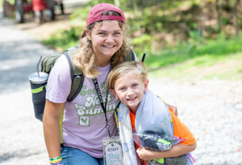 counselor and camper smiling at summer camp.