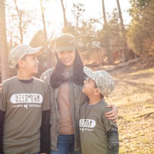 mother and sons smiling for photo at mother son dinner