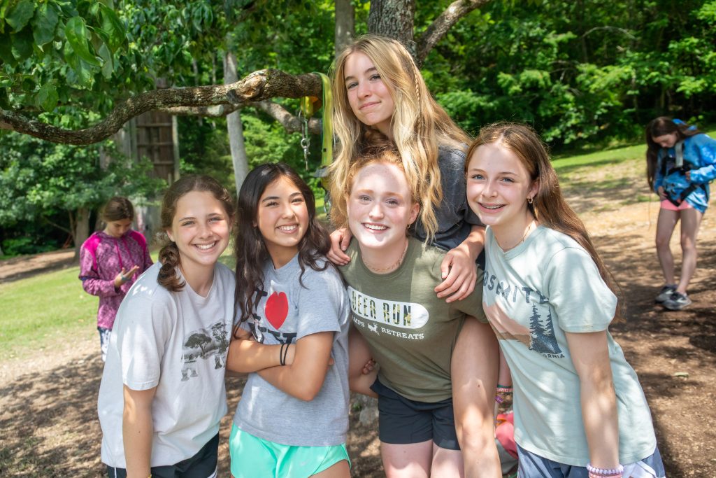 Girl campers smiling with their counselor at Deer Run Camps & retreats overnight camp.