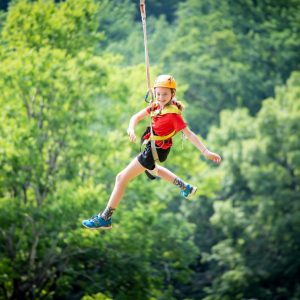 Girl camper on giant swing