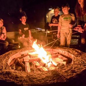 Overnight Winter Campers roasting s'mores over the fire