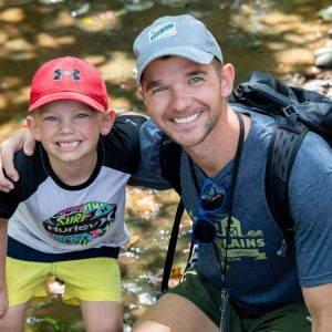 Father and Son smiling at Deer Run Camps & Retreats Father-Son Adventure Weekend.