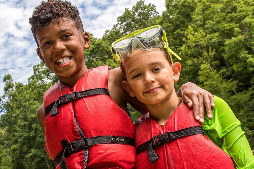 2 day camp boys in life vests at spring valley lake at Deer Run Camps & Retreats
