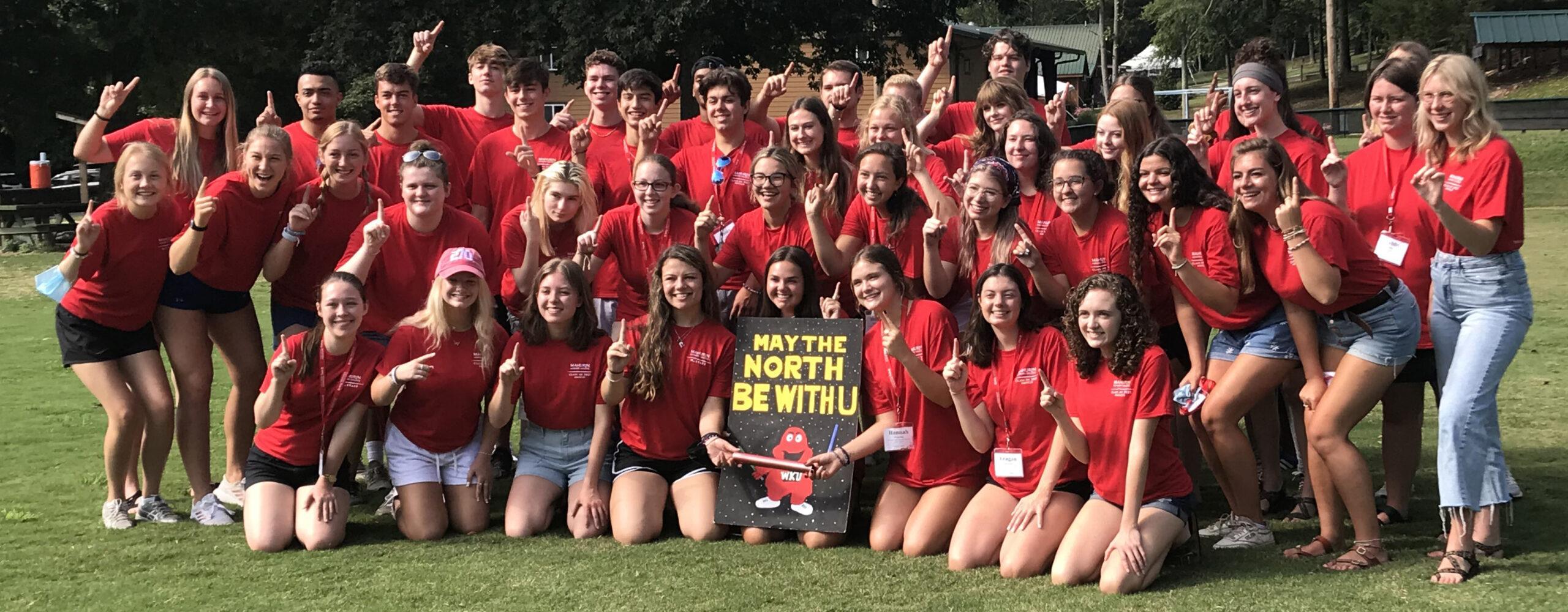 University Group in matching red shirt posing for group photo at Deer Run Camps & Retreats